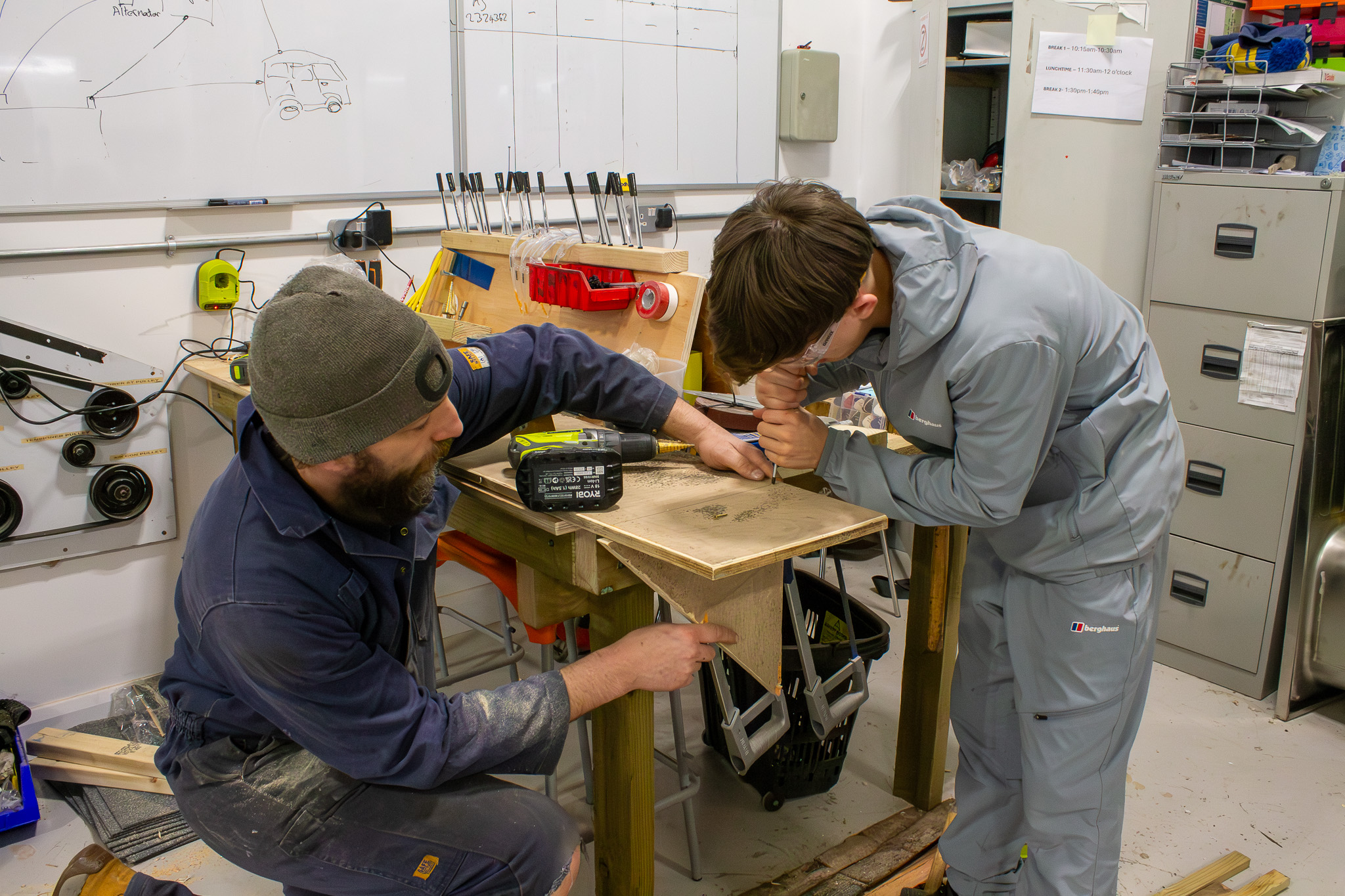 student and teacher at construction workshop