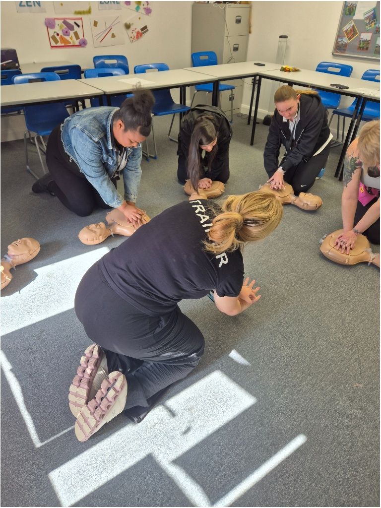 representative demonstrating CPR to students