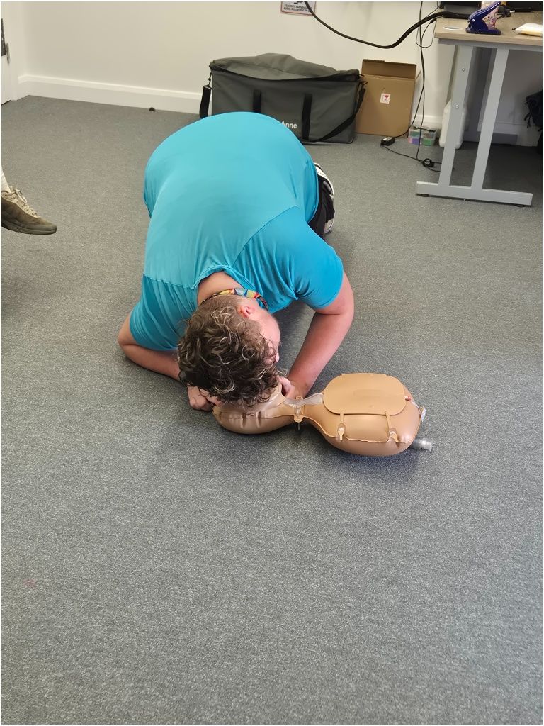 student simulating administering CPR - listening to breathing