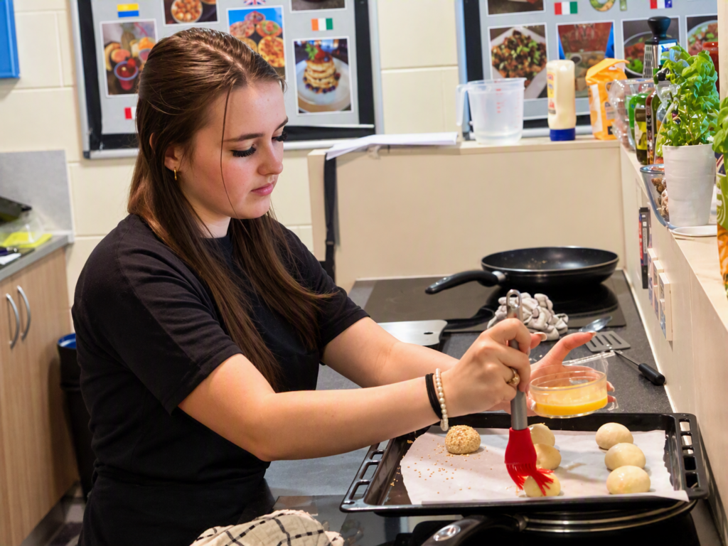 student in kitchen during food tech class